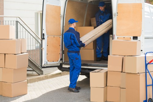 Removal team preparing household items for transport