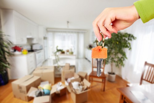 Mover carrying a sofa during a house relocation service