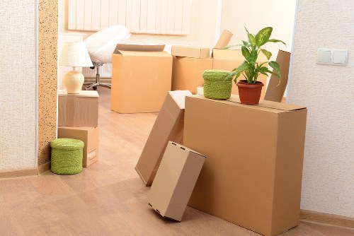 Packed moving boxes and furniture ready for a man and van job
